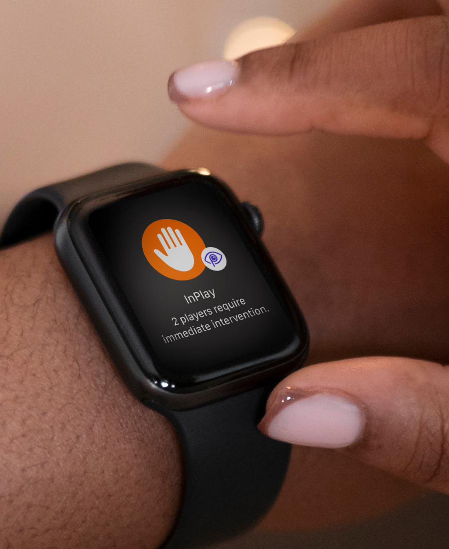Close-up of the InPlay smartwatch showing a live alert